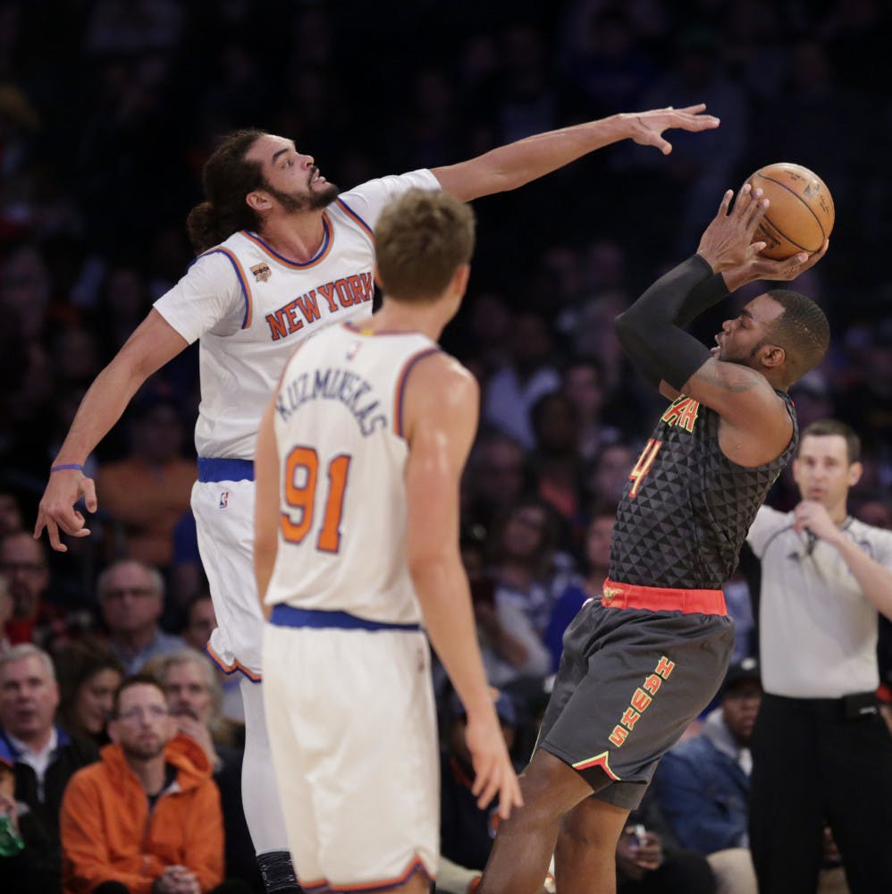 Atlanta Hawks' Paul Millsap, right, tries to get a shot past New York Knicks' Joakim Noah during the first half of the NBA basketball game, Monday, Jan. 16, 2017 in New York. (AP Photo/Seth Wenig)