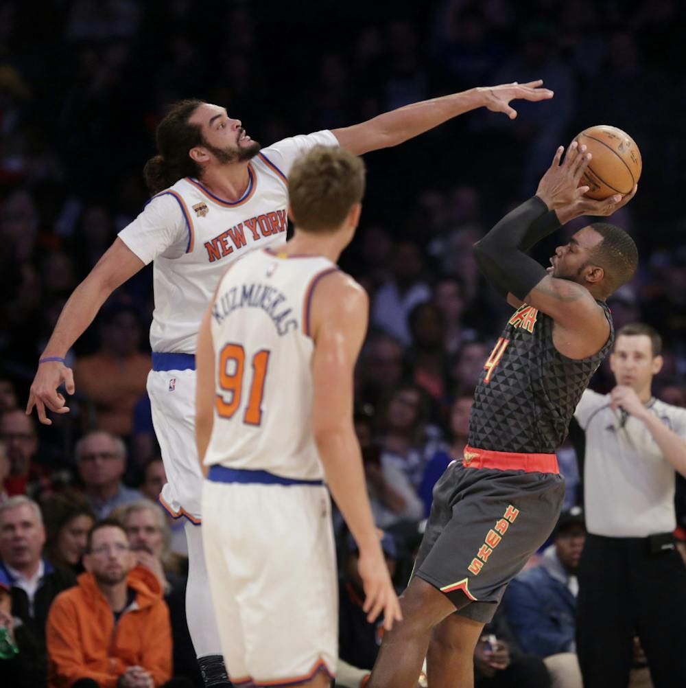 <p>Atlanta Hawks' Paul Millsap, right, tries to get a shot past New York Knicks' Joakim Noah during the first half of the NBA basketball game, Monday, Jan. 16, 2017 in New York. (AP Photo/Seth Wenig)</p>