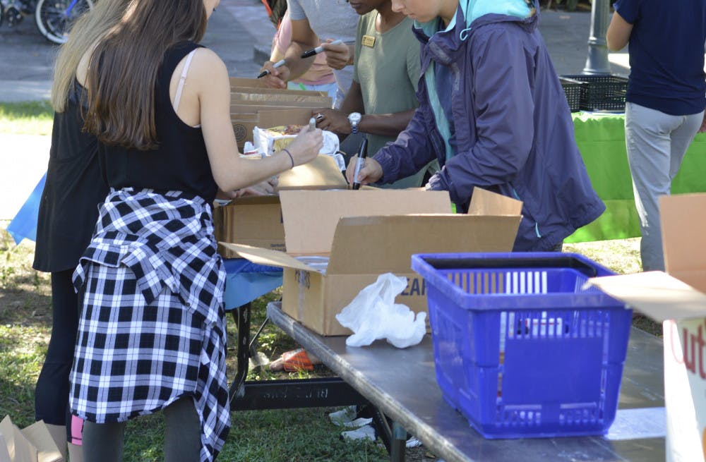 Students organize canned goods and other items at Field and Fork Pantry’s Day of Service on Tuesday.