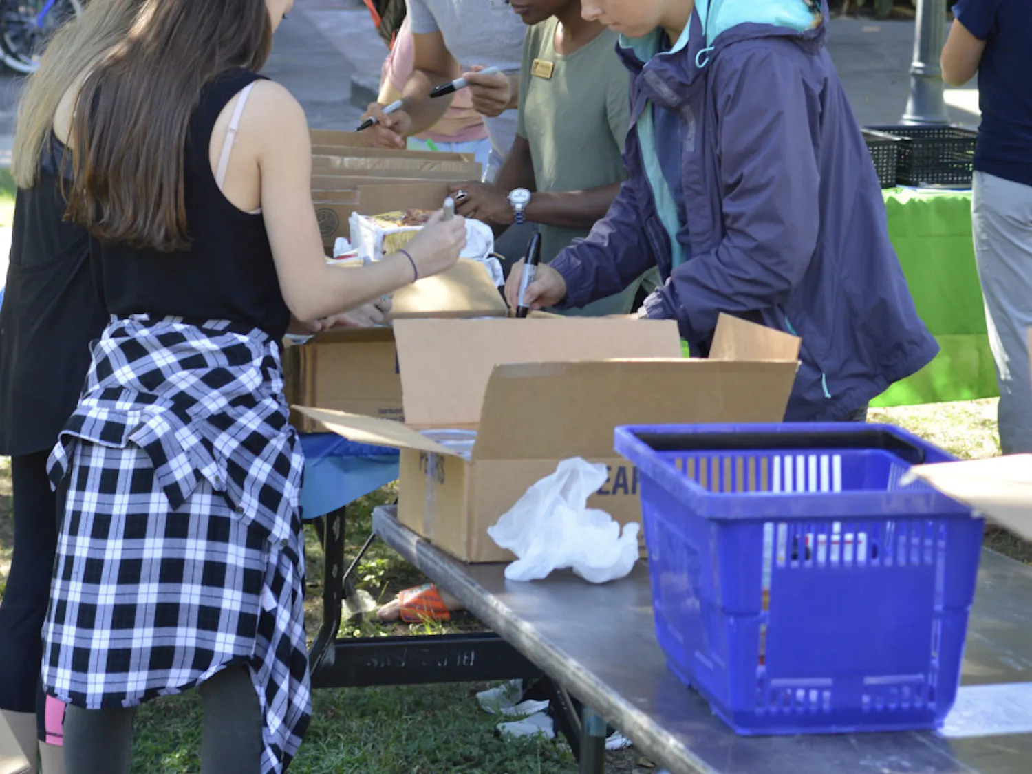Students organize canned goods and other items at Field and Fork Pantry’s Day of Service on Tuesday.