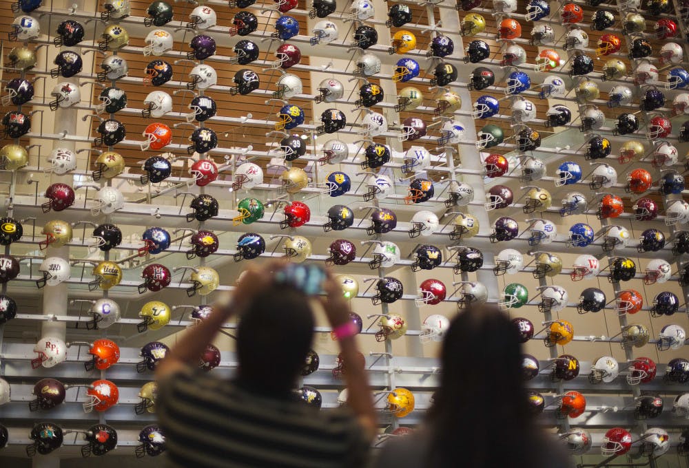 <p>Helmets representing the 768 college football programs in the U.S. are displayed as fans arrive to spend the night in the College Football Hall of Fame, Wednesday, Aug. 13, 2014, in Atlanta. The school associated with a fan's registration card will light up their team's helmet upon swiping the card at the entry to the museum.</p>