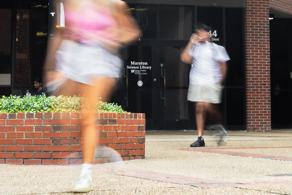 <p>University of Florida students exit the Marston Library, which has reduced its hours of opening. </p>