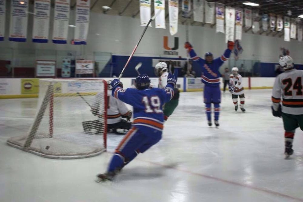 <p>Chance Wolf (center) jumps in celebration after scoring his first goal for the UF club ice hockey team.</p>