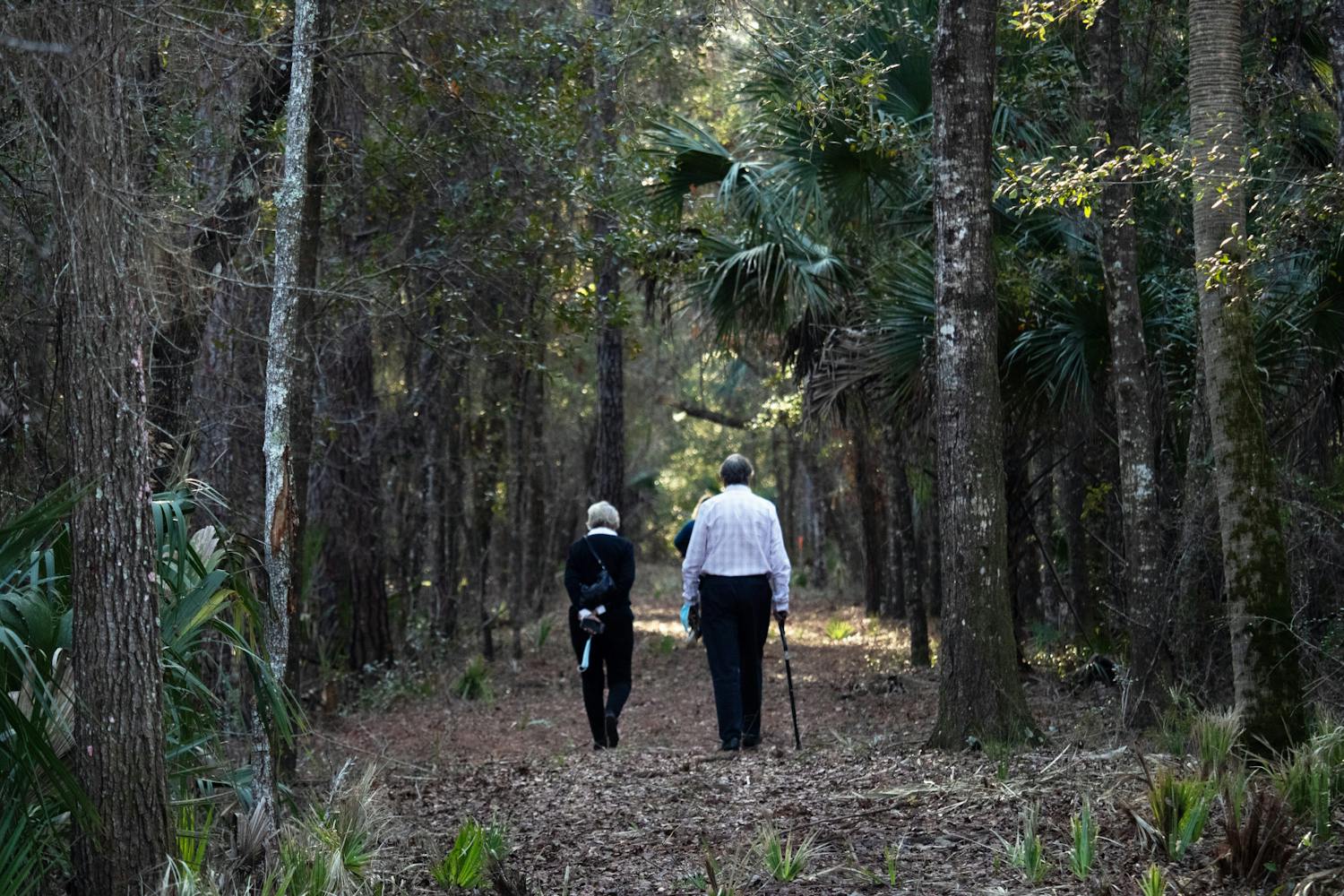 Attendees of the wreath laying ceremony walk through the 5-acre Rosewood property after the ceremony concludes Sunday, Jan. 8, 2023.