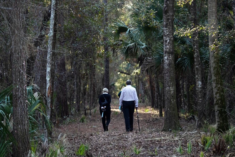<p>Attendees of the wreath laying ceremony walk through the 5-acre Rosewood property after the ceremony concludes Sunday, Jan. 8, 2023.</p>