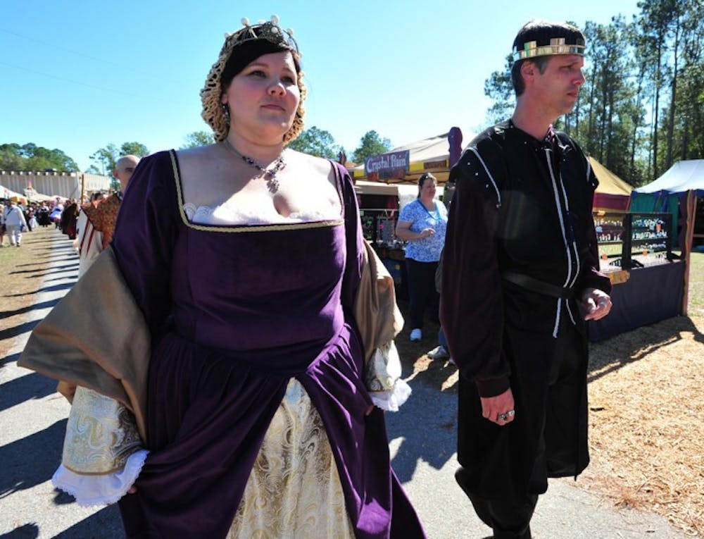 <p>Queen Eleanor, played by Stephanie Tyson, 30, and King Henry II, played by Tom Dalton, 43, march through the 26th annual Hoggetowne Medieval Faire on their way to perform in a live-action chess game.</p>