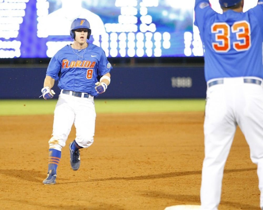 <p>Senior outfielder Daniel Pigott (8) failed to tag up from third base and score the tying run after Preston Tucker hit a fly ball to right field in the bottom of the ninth inning in No. 1 Florida’s 7-6 loss No. 12 LSU.</p>