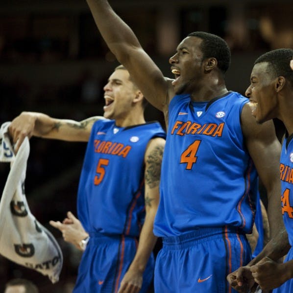 Sophomore center Patric Young (4), shown here with guard Scottie Wilbekin (5) and forward Casey Prather (24), has been dealing with tendinitis in his right ankle.