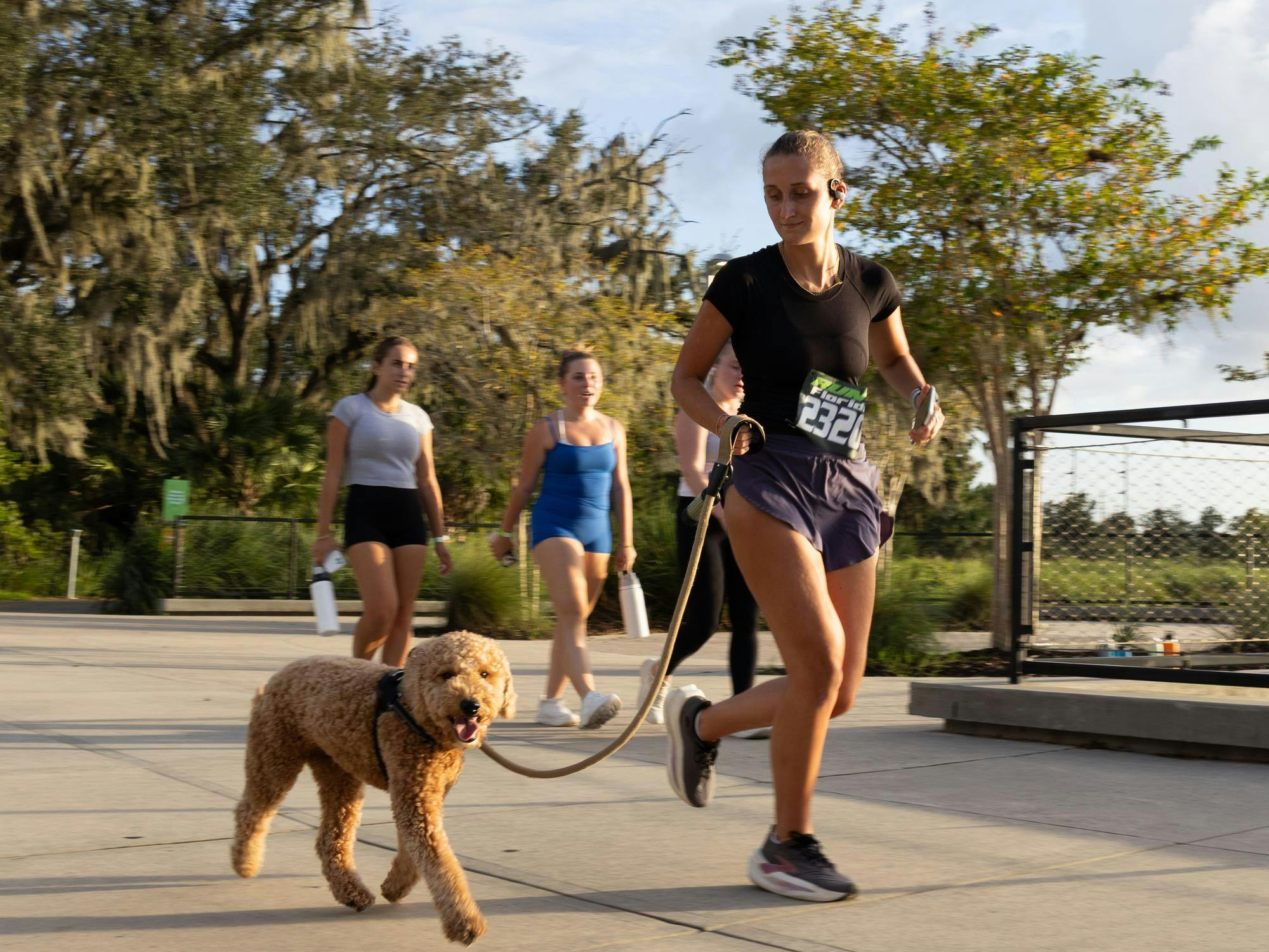 Runner with dog at UF’s Gator Growl Chomp for Charity 5k with The Humane Society of North Central Florida in Depot Park on Wednesday, Sept. 16, 2026 in Gainesville, Fla.