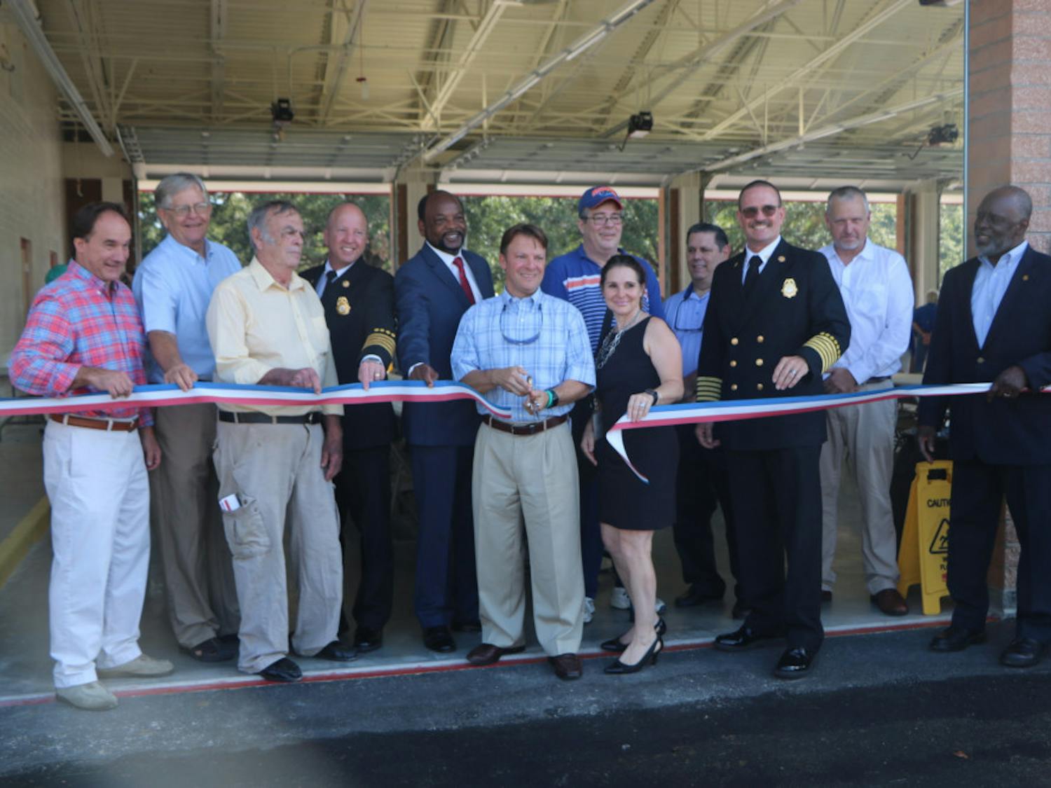 Alachua County Commissioner Ken Cornell cuts the ribbon in front of the new Fire Rescue Station 33, located at 5901 NW 34th Blvd., on Friday. The station will house six ambulances.