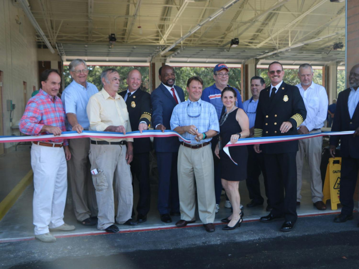Alachua County Commissioner Ken Cornell cuts the ribbon in front of the new Fire Rescue Station 33, located at 5901 NW 34th Blvd., on Friday. The station will house six ambulances.