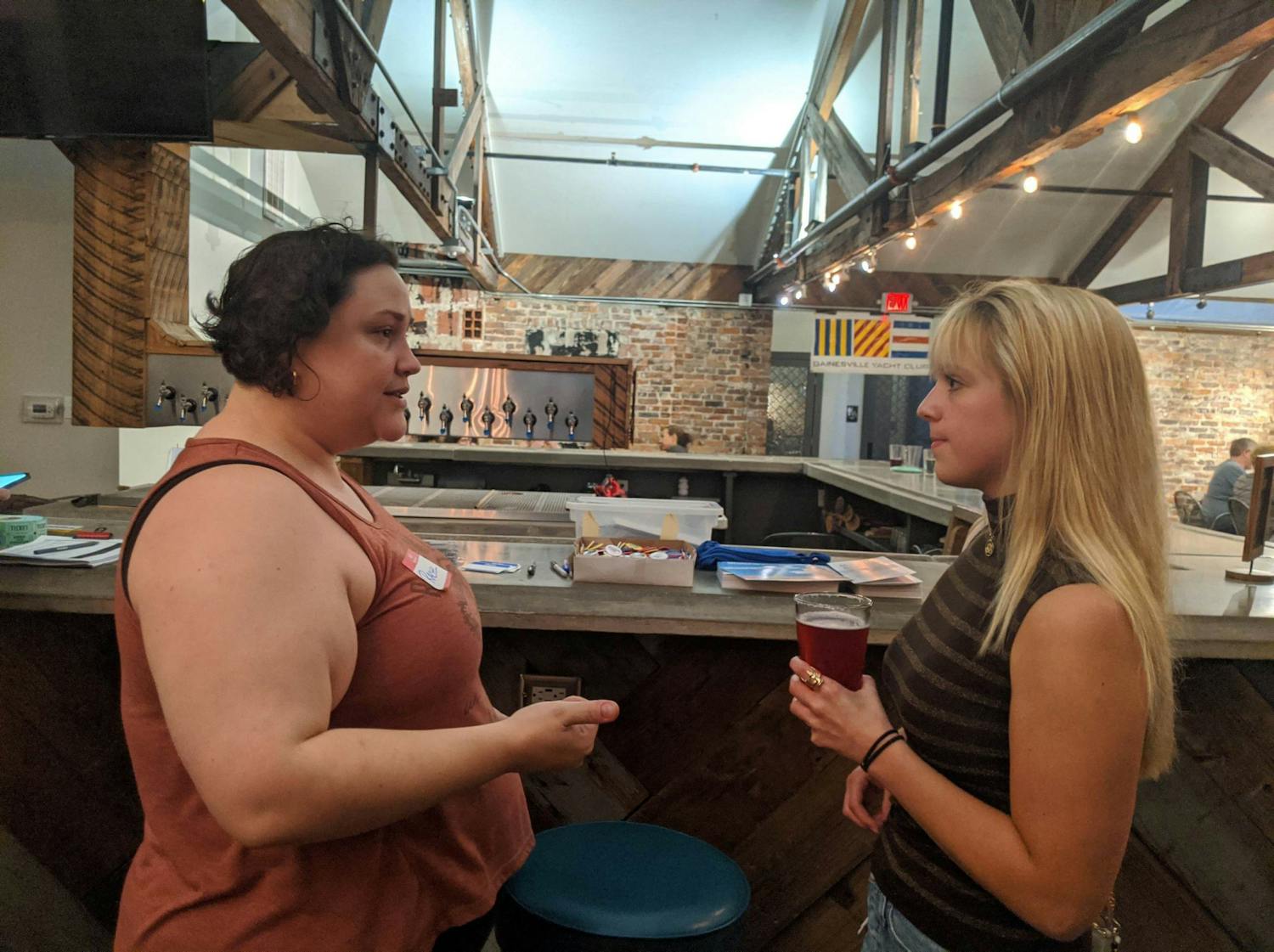 UF Graduate Assistants United Co-President Rachel Hartnett talks to Talia Jacobsen, a new graduate assistant from Chicago, at GAU’s first “payday party,” Friday, Sept. 9, 2022.