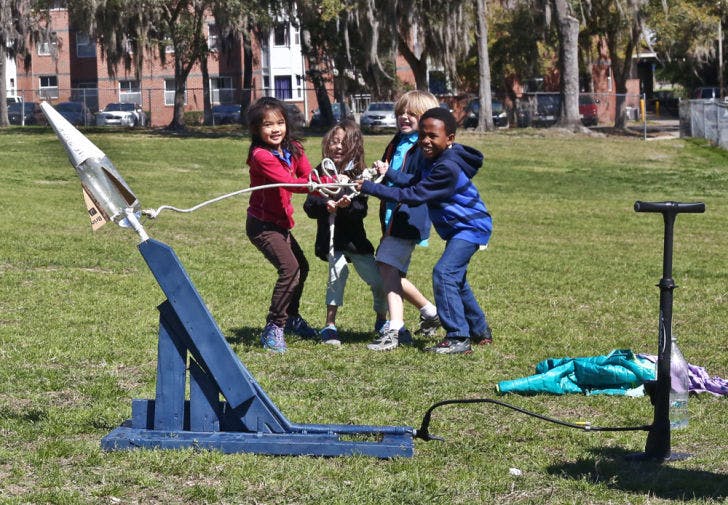 Second and third graders from Idylwild Elementary School launch bottle rockets on Flavet Field on Thursday morning. The American Institute of Aeronautics and Astronautics at UF assisted the students in building the rockets and launching them for the field trip.