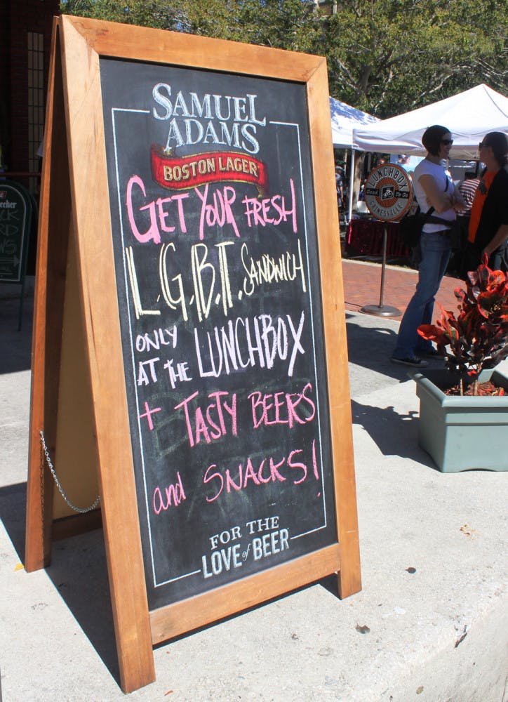 A sign advertising a Pride-friendly specialty sandwich sits in front of The Lunchbox, a cafe in downtown Gainesville.