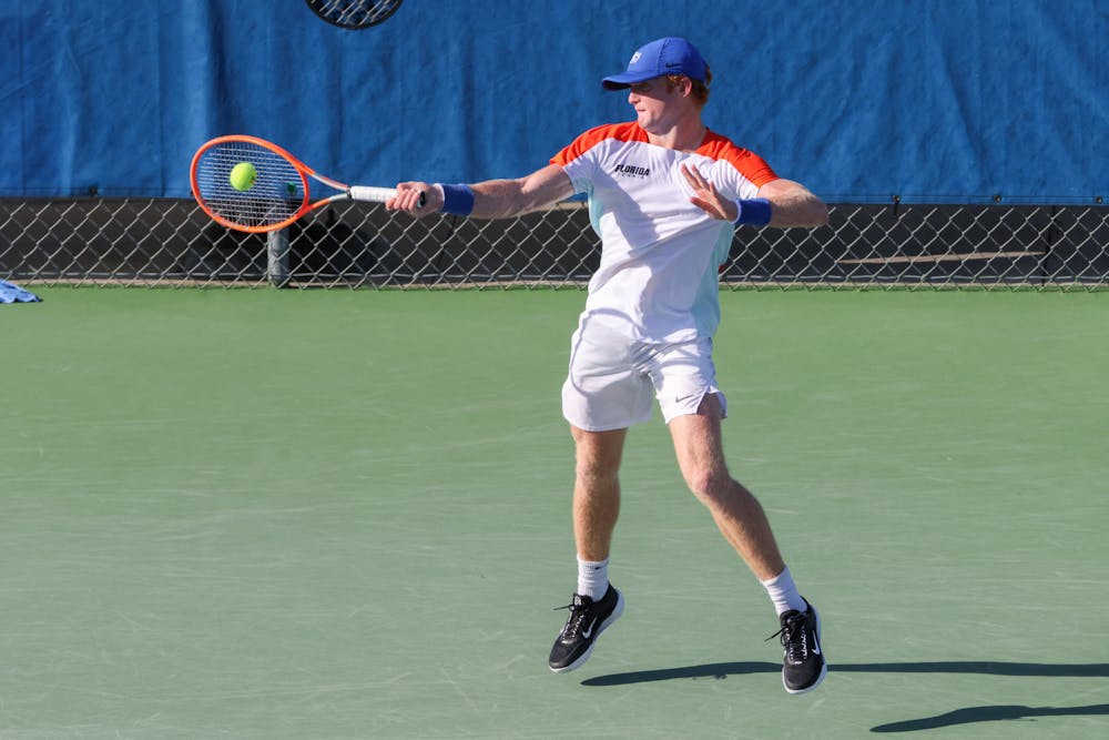 Florida freshman Jonah Braswell hits the ball in his doubles match during the Gators' 6-1 win against the Arkansas Razorbacks Friday, March 24, 2023.