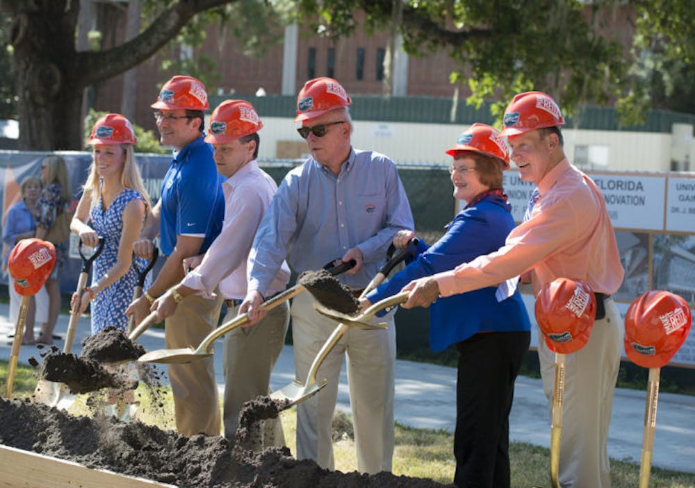 <p>Student Body President Christina Bonarrigo, state Rep. Seth McKeel and UF President Bernie Machen were among the people who dug into dirt with golden shovels during the groundbreaking ceremony for the Reitz Union expansion.</p>