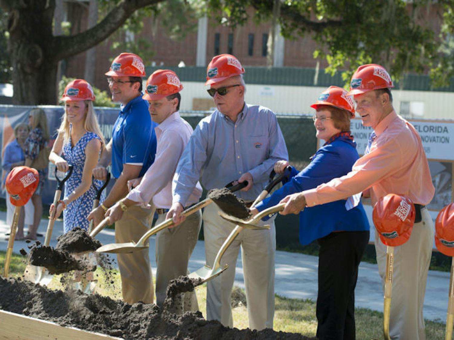 Student Body President Christina Bonarrigo, state Rep. Seth McKeel and UF President Bernie Machen were among the people who dug into dirt with golden shovels during the groundbreaking ceremony for the Reitz Union expansion.