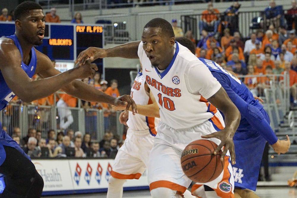 <p>Dorian Finney-Smith dribbles the ball during Florida's 88-79 loss to Kentucky on March 1, 2016, in the O'Connell Center.</p>