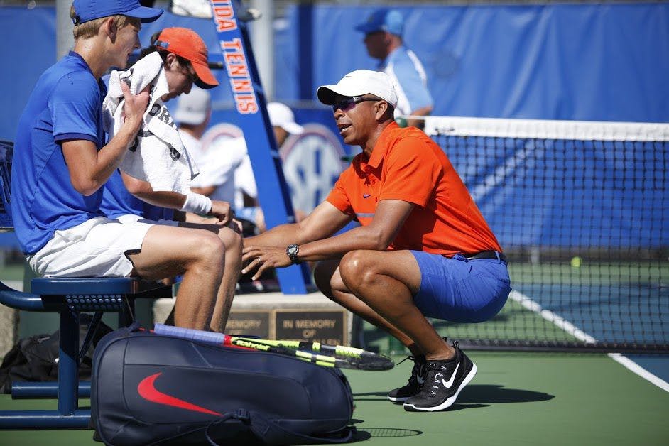 UF coach Bryan Shelton talks with freshman Johannes Ingildsen during Florida's 4-2 win against UCLA on Feb. 5, 2017, at the Ring Tennis Complex.