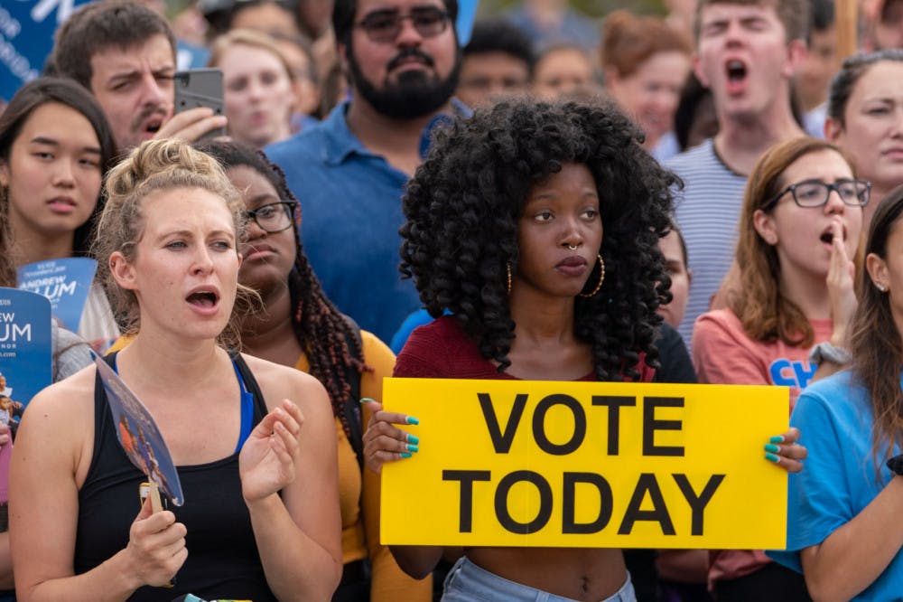 An attendee of Mayor and gubernatorial candidate Andrew Gillum's rally on UF's campus Friday holds up a sign urging others to vote in the upcoming election. Gillum spoke to an assembled crowd of students and citizens outside of the Reitz Union building about his campaign platform and pressed everyone in attendance to vote.