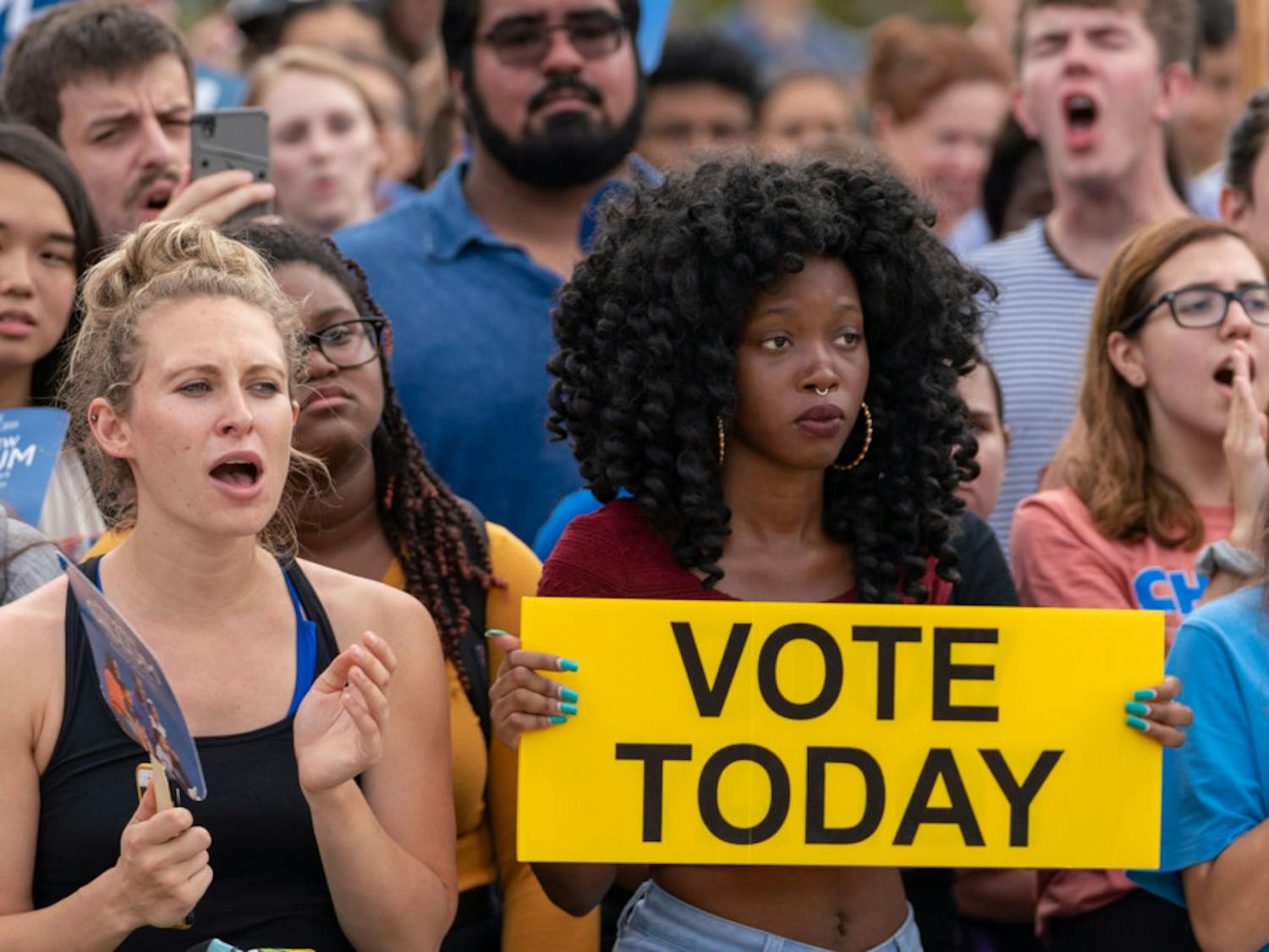An attendee of Mayor and gubernatorial candidate Andrew Gillum's rally on UF's campus Friday holds up a sign urging others to vote in the upcoming election. Gillum spoke to an assembled crowd of students and citizens outside of the Reitz Union building about his campaign platform and pressed everyone in attendance to vote.