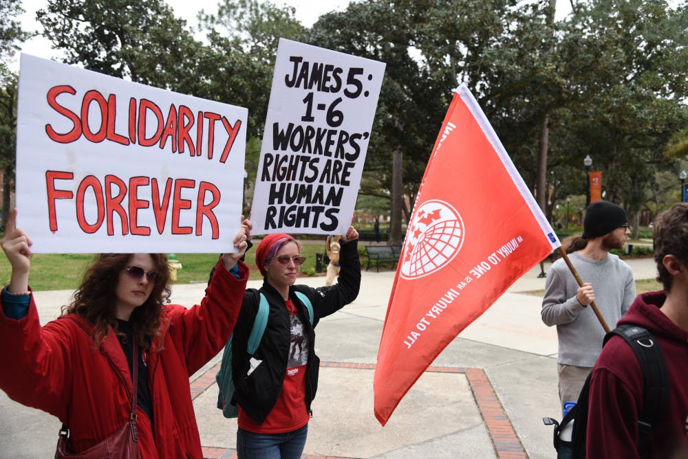 <p>Almost 50 protesters gather outside President Kent Fuchs’ office on Feb. 21 to advocate for better working conditions and wages from Aramark, UF’s food service company. A new coalition plans to protest virtually in light of the COVID-19 outbreak.</p>