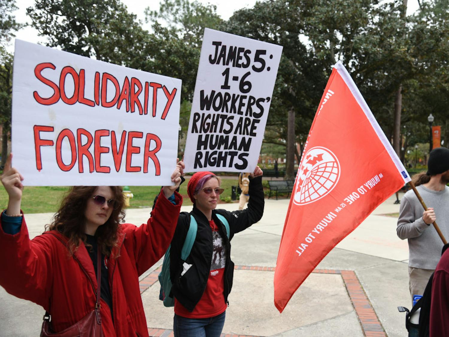Almost 50 protesters gather outside President Kent Fuchs’ office on Feb. 21 to advocate for better working conditions and wages from Aramark, UF’s food service company. A new coalition plans to protest virtually in light of the COVID-19 outbreak.