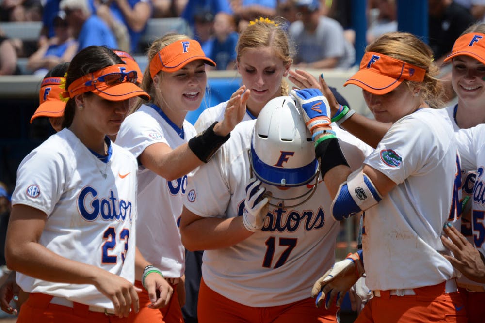 <p>UF players celebrate with Lauren Haeger after she hits a solo home run during Florida's 7-0 win against Kentucky during the 2015 NCAA Super Regionals on May 23, 2015, at Katie Seashole Pressly Stadium.</p>