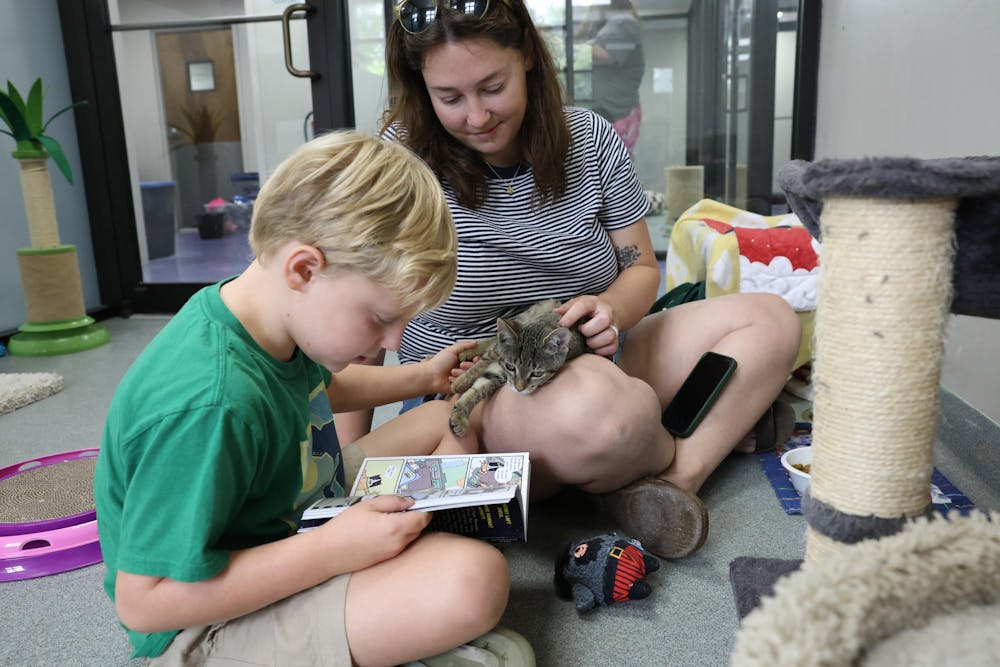Michelle and Finnley Duncan read to Poppi during the Purrs and Tails event hosted by the Humane Society of North Central Florida, Saturday, June 20, 2026,  in Gainesville, Fla.
The event was meant to encourage kids to practice their reading skills and socialize with the cats.