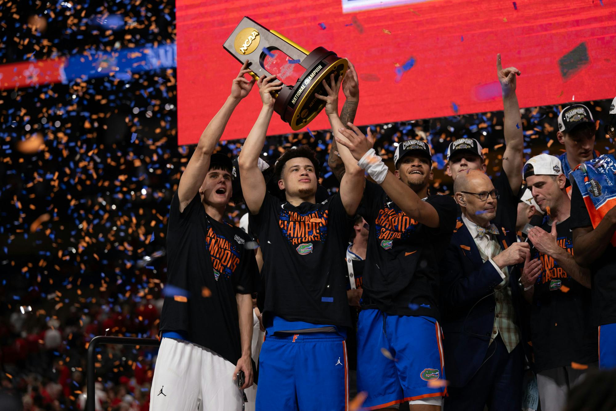 Florida Gators guard Walter Clayton Jr. (1) surrounded by teammates, raises the national championship trophy after winning the National Championship against the Houston Cougars in the NCAA Tournament on Monday, April 7, 2025, in San Antonio, Texas.