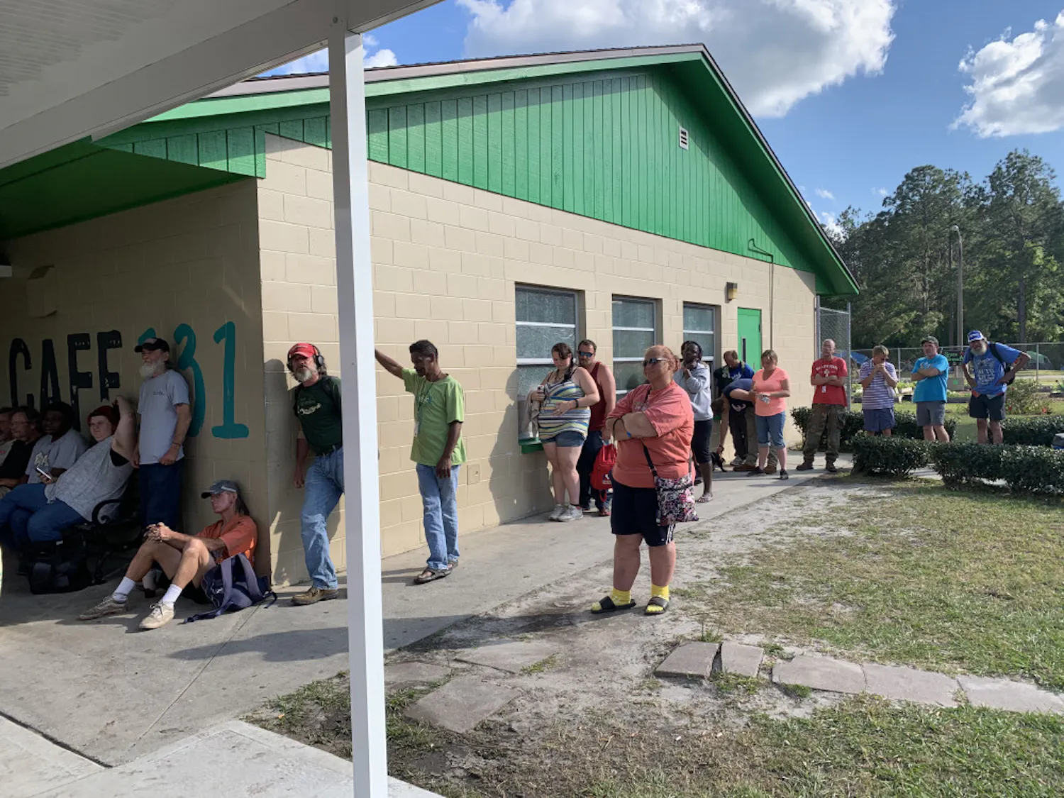 Attendees wait in line for meals outside Cafe 131 at Grace Marketplace on Monday evening. The non-profit assistance shelter celebrated serving its half millionth meal.