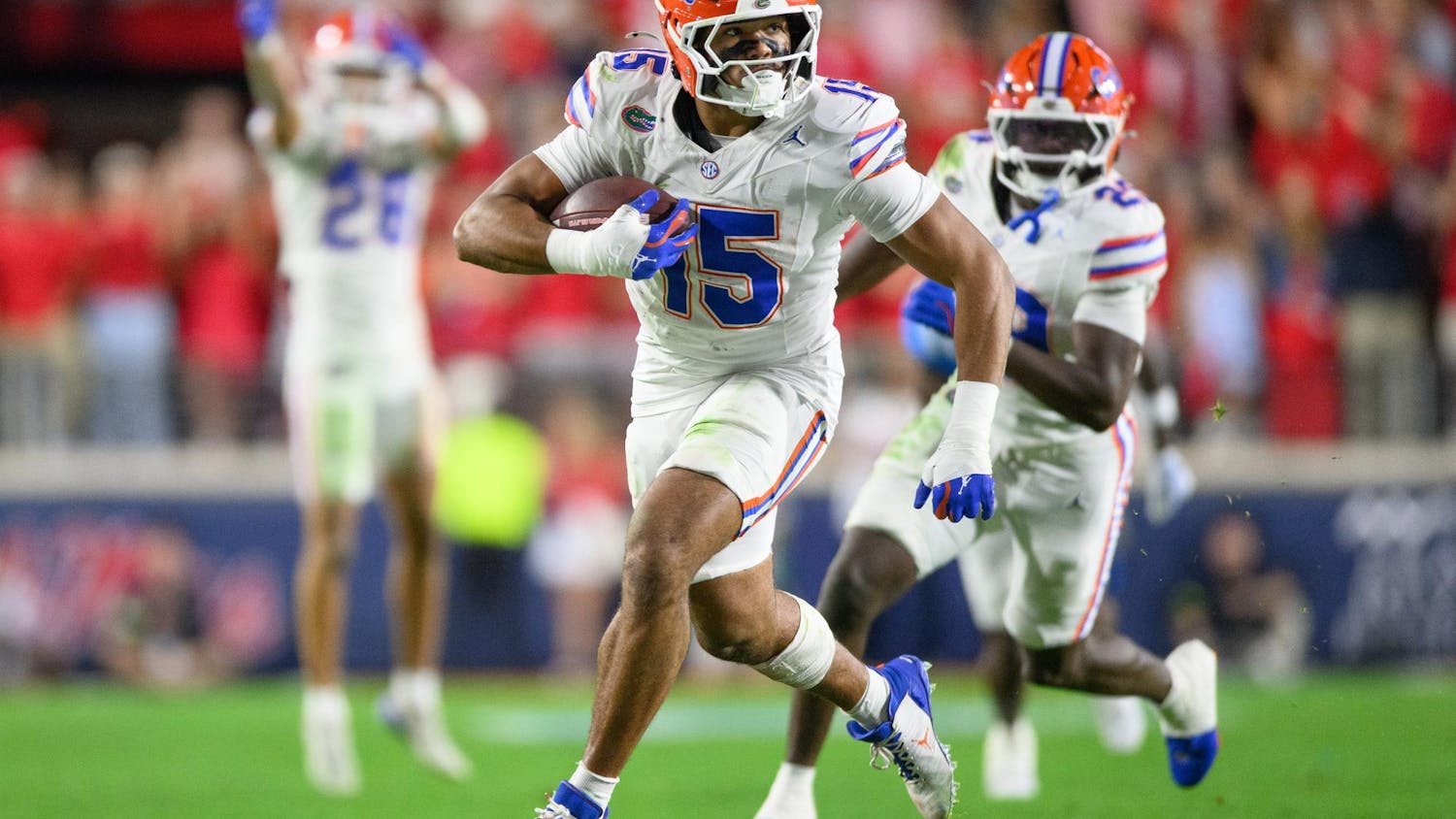 Florida edge rusher Jayden Woods (15) runs with the ball after an interception during an NCAA college football game, Saturday, Nov. 15, 2025, in Oxford, Miss.