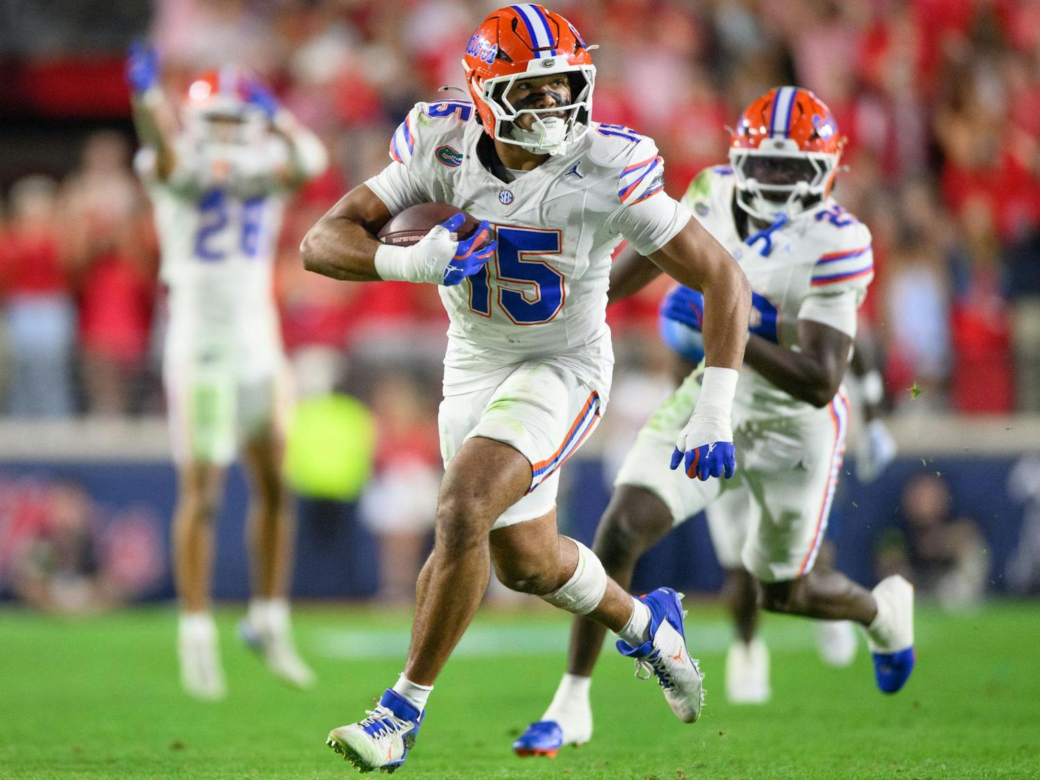 Florida edge rusher Jayden Woods (15) runs with the ball after an interception during an NCAA college football game, Saturday, Nov. 15, 2025, in Oxford, Miss.