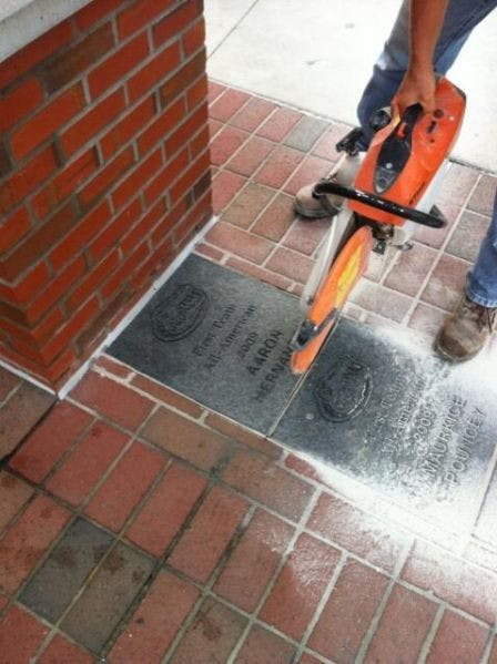 Aaron Hernandez’s All-America brick is removed from outside the James W. “Bill” Heavener Football Complex on Thursday. UF decided to remove the brick while the former UF tight end faces murder charges. &nbsp;
Ed. note: The caption originally misstated the location of the brick in one location. It is not at Gator Walk, but outside the Heavener Football Complex.