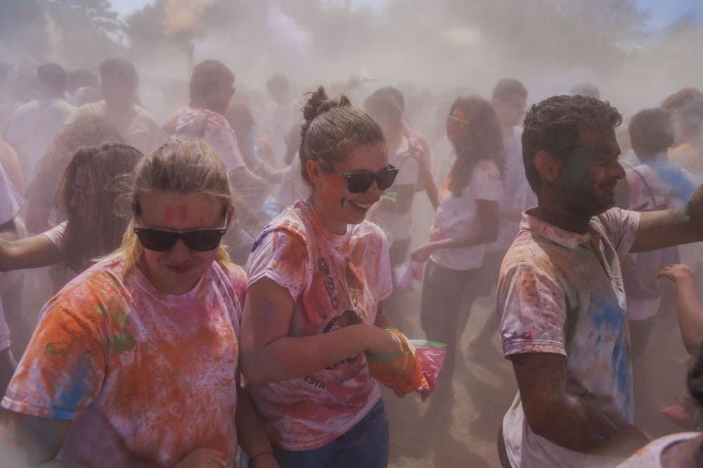 A group of students laugh as more than 1,000 people throw paint during the UF Holi Festival of Colors on Sunday.
&nbsp;