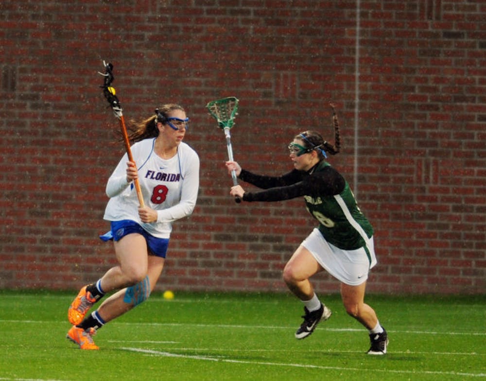 <p>Shannon Gilroy drives toward the net during Florida’s 21-5 win against Jacksonville on Wednesday at the Donald R. Dizney Stadium. Gilroy scored seven points against the Dolphins.</p>