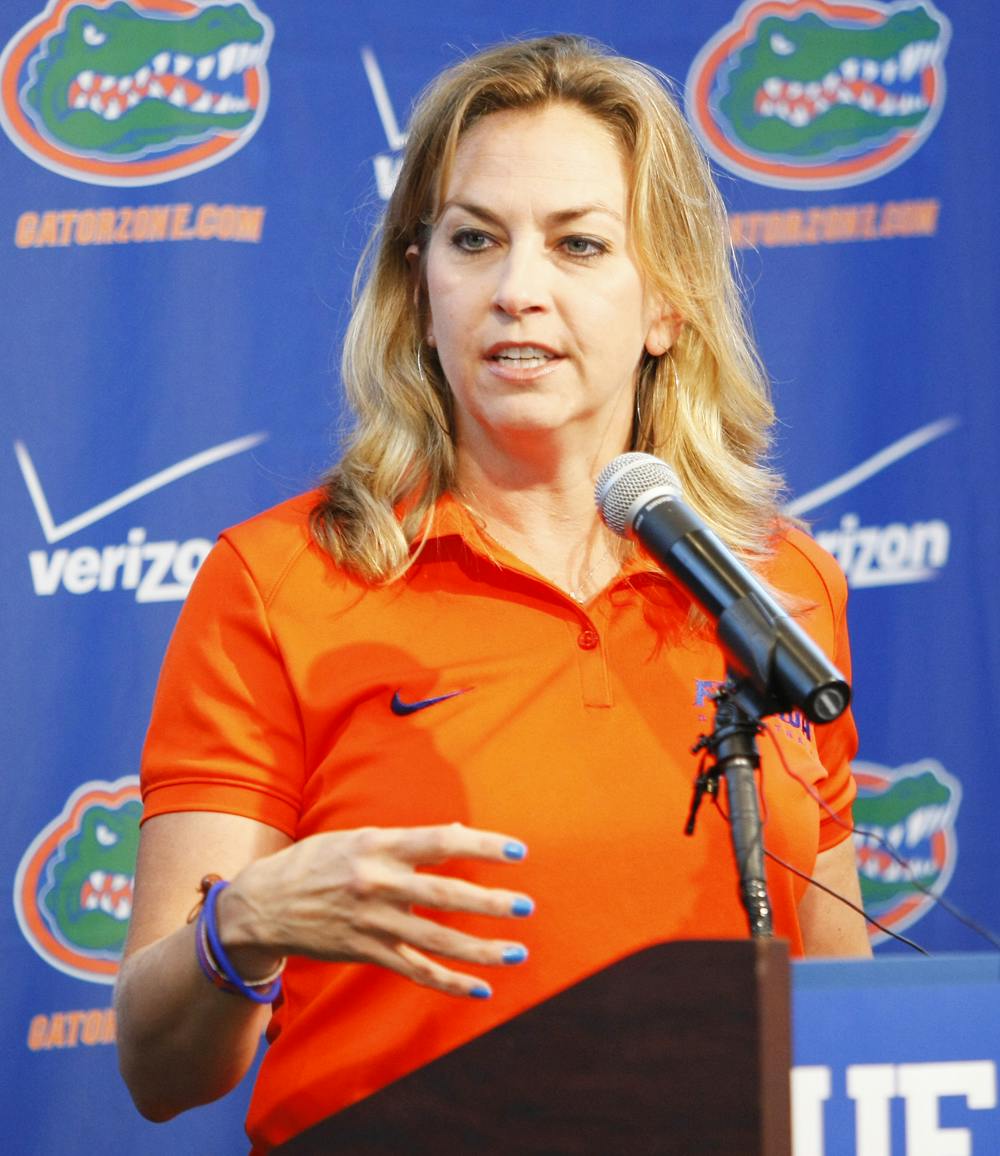 Coach Amanda Butler speaks at the podium during UF’s media day on Oct. 10. Despite a high win total, UF has never finished higher than fourth in the SEC under Butler. 

