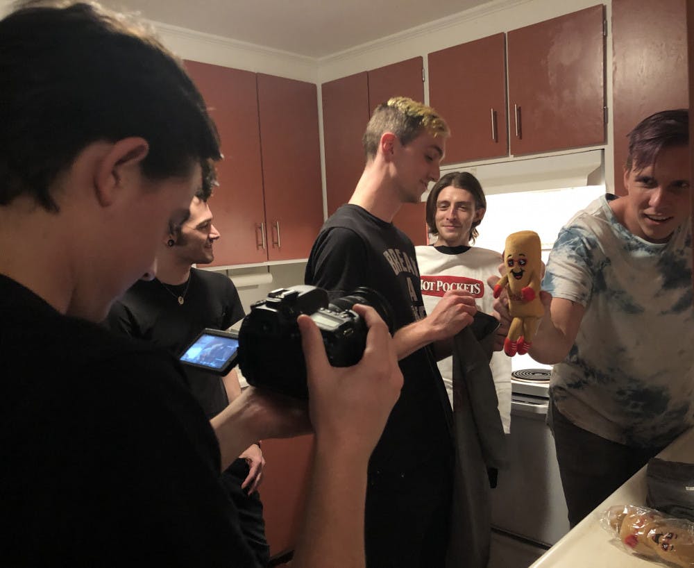 <p>Behind the scenes of Arrows in Action’s <span class="il">Hot</span> <span class="il">Pockets</span> unboxing video. The band’s manager, Jacob McKay, films bassist Tony Farah, guitarist Matt Fowler, lead vocalist Victor Viramontes-Pattison and drummer Jesse Frimmel (from left to right).</p>