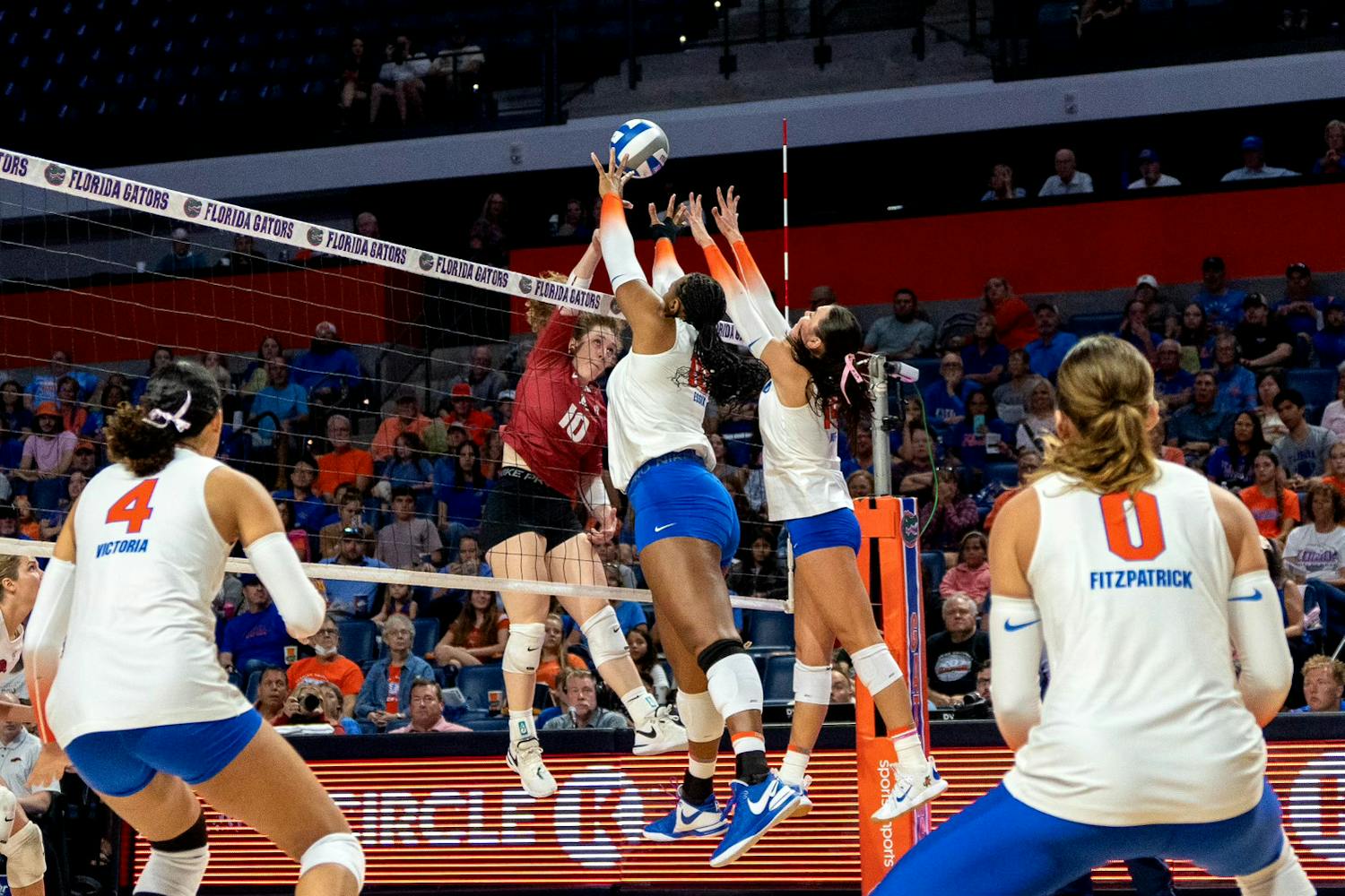 Two Gators volleyball players attempt to block the ball in Florida's 3-0 loss to the Arkansas Razorbacks on Sunday, Oct. 29, 2023.