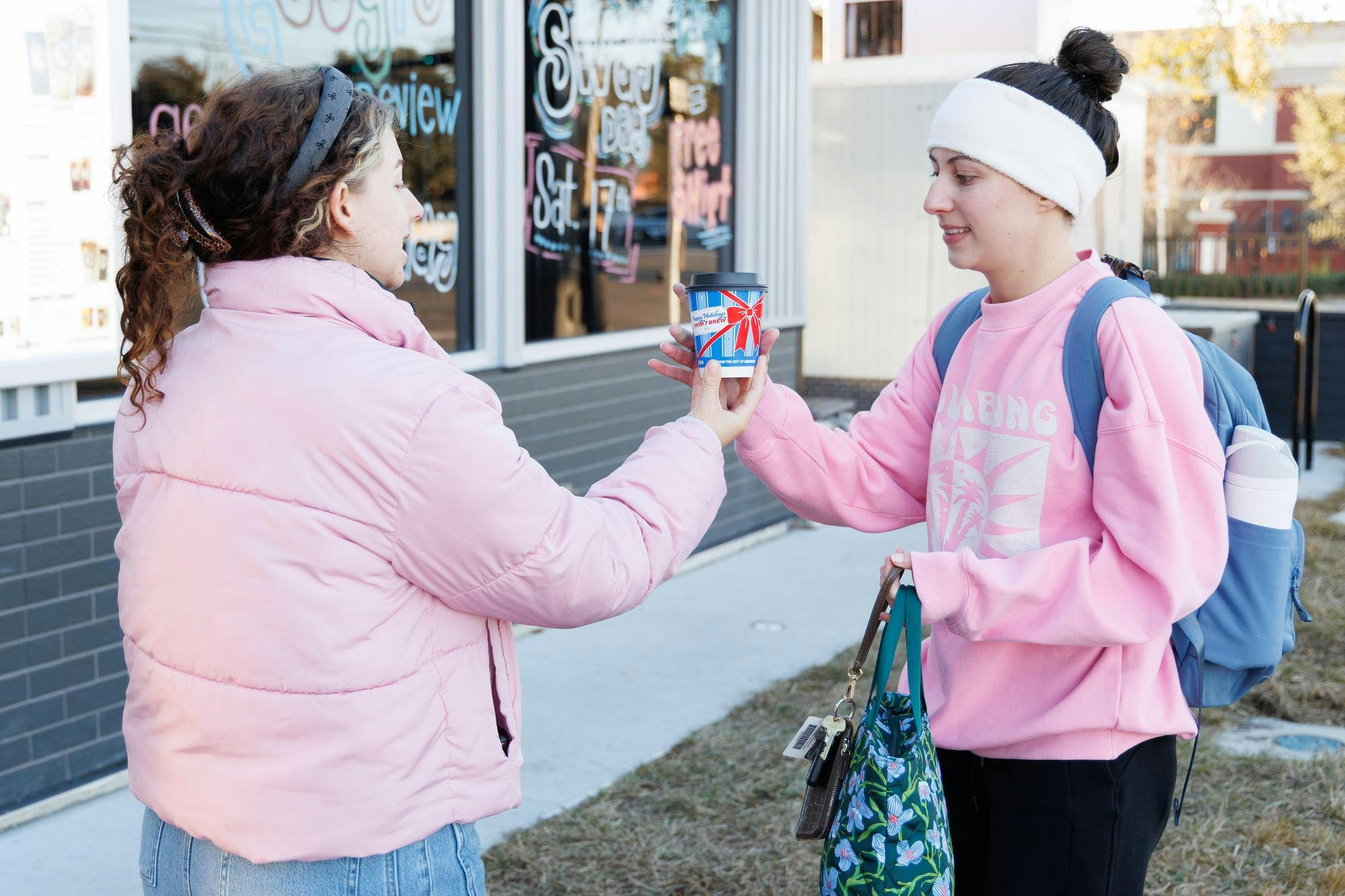 7 Brew Coffee employee Ali Barrett hands Kristen Adams her drink at their new Gainesville location, Friday, Jan. 16, 2026.