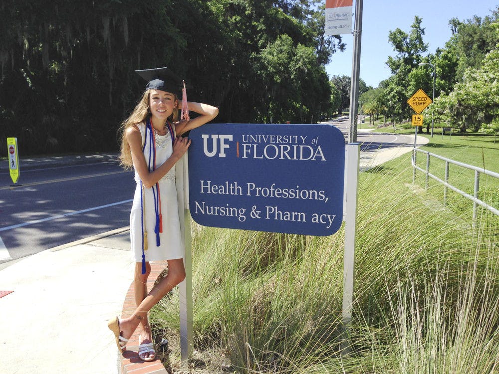 <p>Kristen Fox, 22, poses next to a sign outside the Health Professions, Nursing and Pharmacy School after her graduation in May 2014 with a health science degree. Fox has gastroparesis with general dysmotility of the intestinal tract, a stomach disorder where her paralyzed muscles cannot break down food.</p>