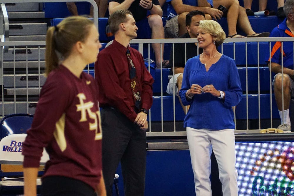 <p>UF coach Mary Wise (right) talks with FSU coach Chris Poole prior to Florida's 3-1 win on Sept. 20, 2015, in the O'Connell Center.</p>