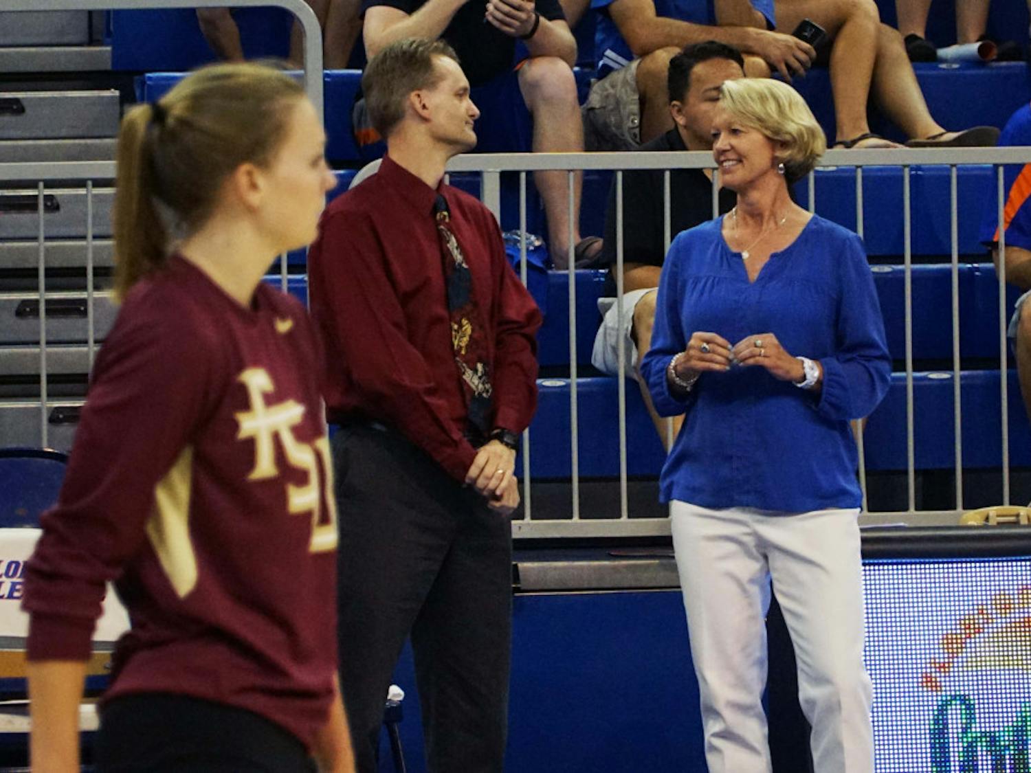 UF coach Mary Wise (right) talks with FSU coach Chris Poole prior to Florida's 3-1 win on Sept. 20, 2015, in the O'Connell Center.