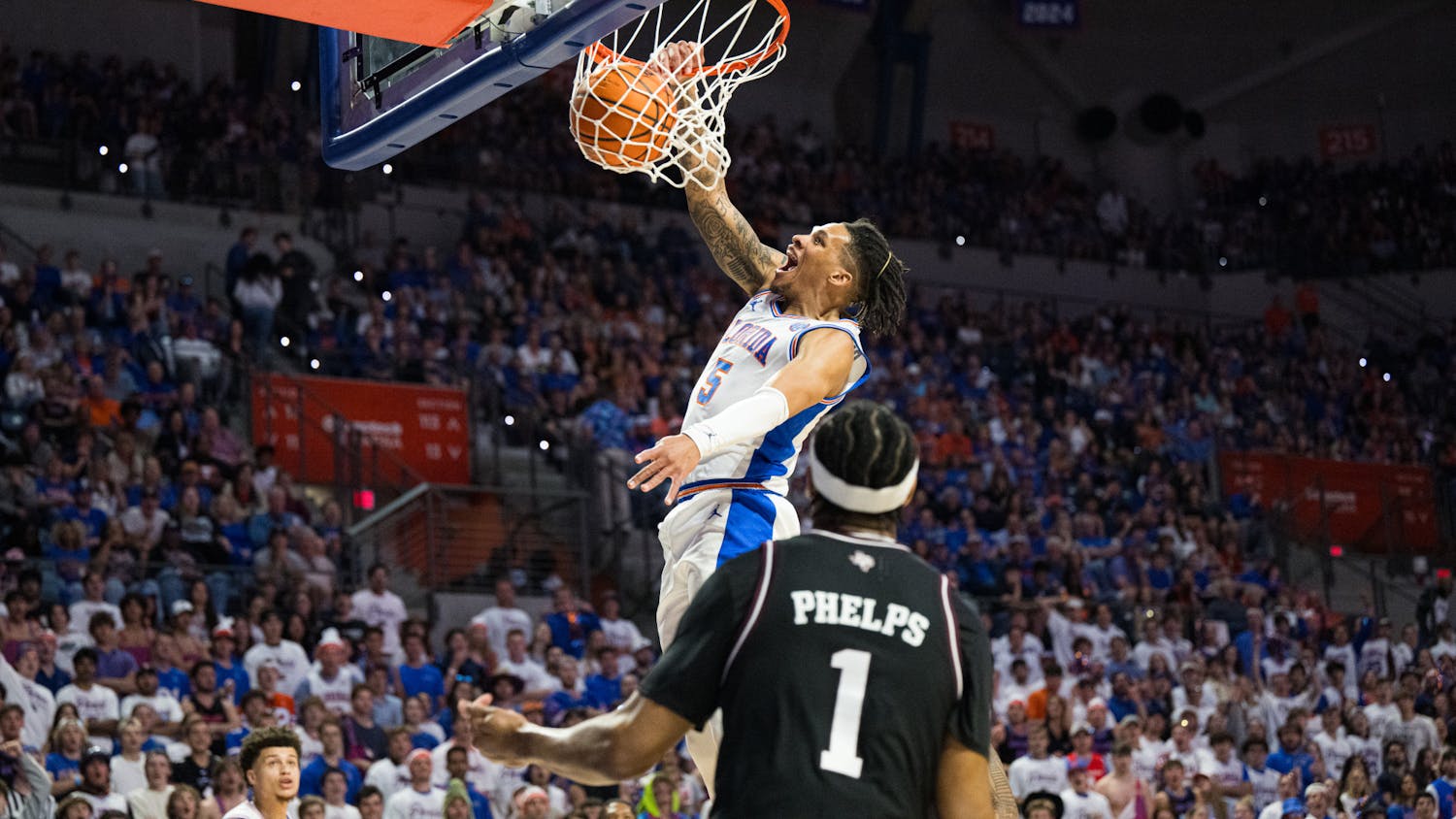 Florida Gators guard Will Richard (5) dunks the ball in a basketball game against Texas A&M on Saturday, March 1, 2025, in Gainesville, Fla.