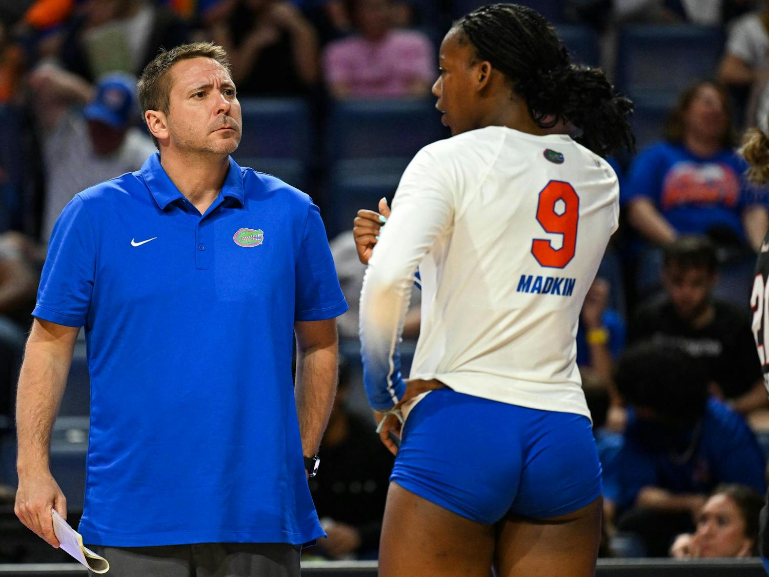 Florida Gators Volleyball head coach Ryan Theis discusses a play with outside hitter Aniya Madkin (9) during a volleyball match against PVK Olymp Praha of the Czech Republic, on Tuesday, Aug. 26, 2025, at the O'Connell Center in Gainesville, Fla.