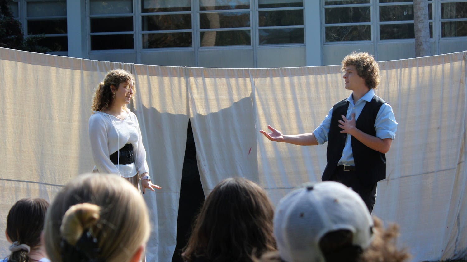 Makena Vargo (left) and James Bilderback (right) act out a scene from Shakespeare’s Romeo and Juliet on the Reitz Union North Lawn during the event hosted by UF Shakespeare in the Park on Sunday, Dec. 5, 2021.
