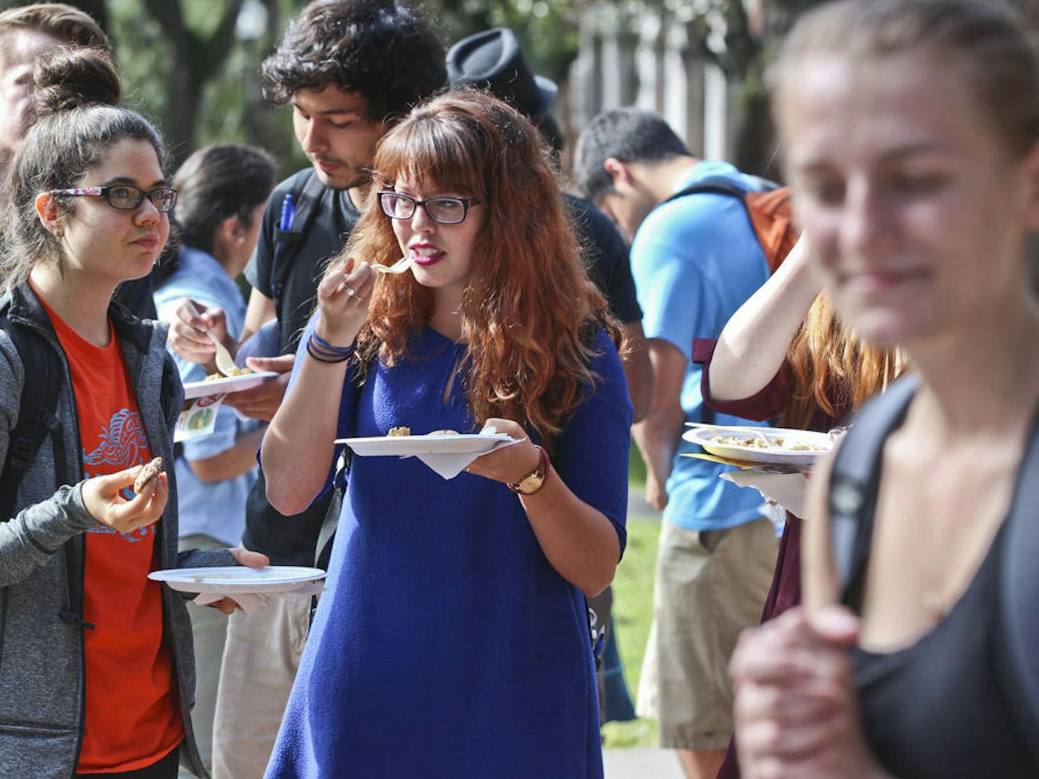 McShane Ingalls, left, a 20-year-old UF nutritional sciences junior, and Kristen Ratliff, a 21-year-old political science senior, eat a vegan Thanksgiving meal at the Plaza of the Americas on Nov. 20, 2015. The Student Animal Alliance provided a lunch of Tofurkey, mashed potatoes, gravy and cookies as well as literature on the importance of going vegan.