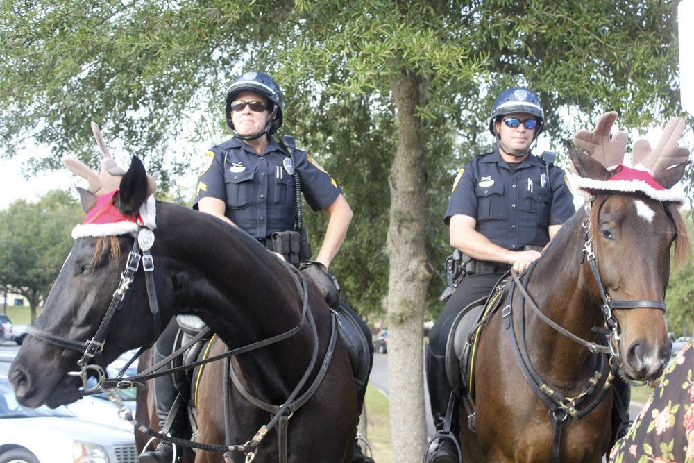 Gainesville Police Cpl. Tracy Fundenburg, left, sits on police horse Zeus, and GPD Officer Tom Lardner sits on police horse Bolt, outside The Oaks Mall on Friday afternoon. Bolt will replace retired police horse Blue.