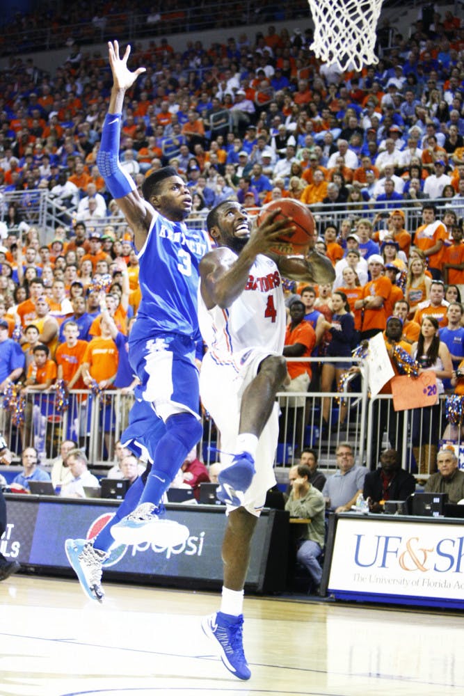 Center Patric Young (4) attempts a layup during UF’s 69-52 win against UK on Tuesday in the O’Connell Center.
