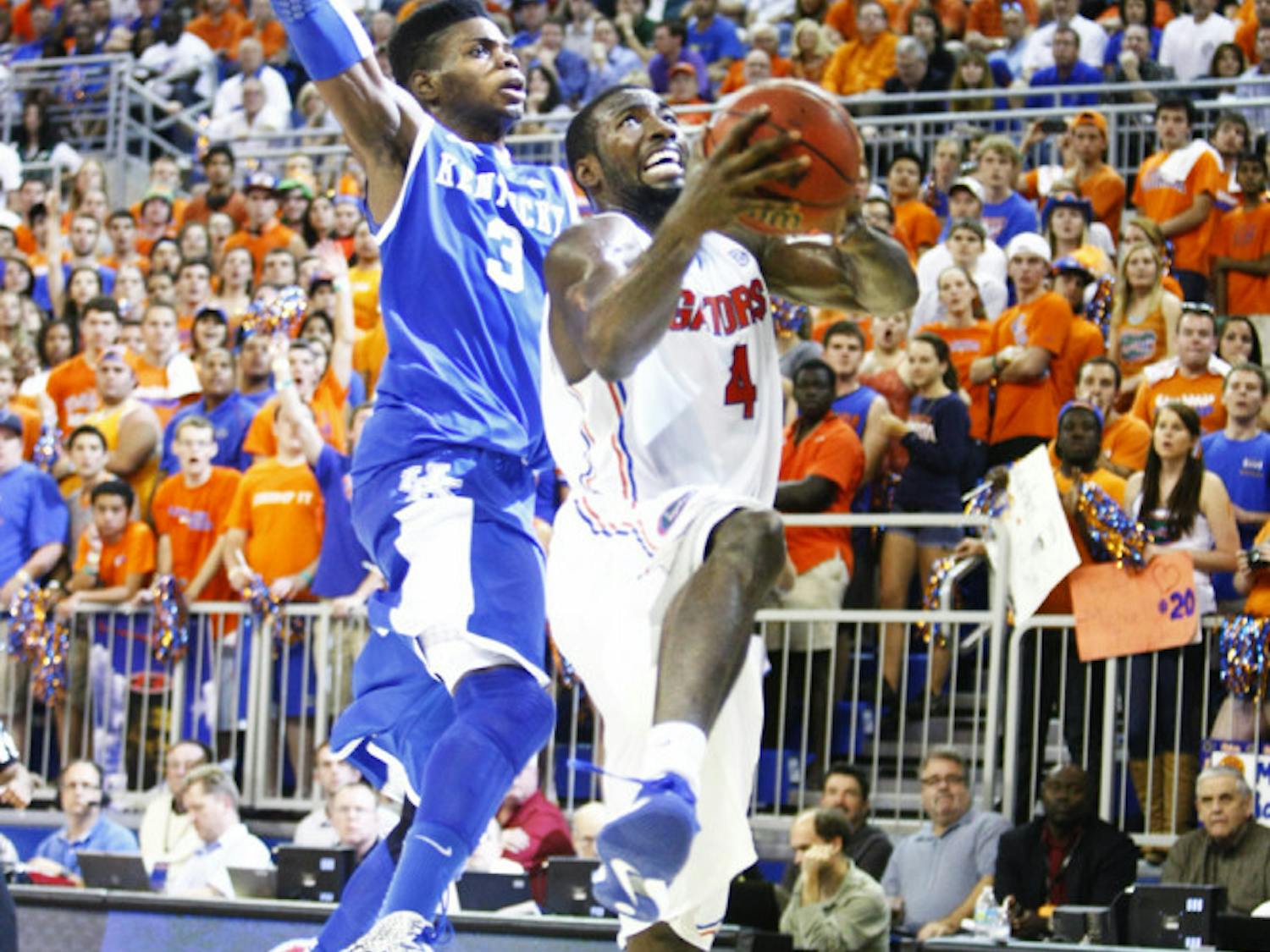 Center Patric Young (4) attempts a layup during UF’s 69-52 win against UK on Tuesday in the O’Connell Center.